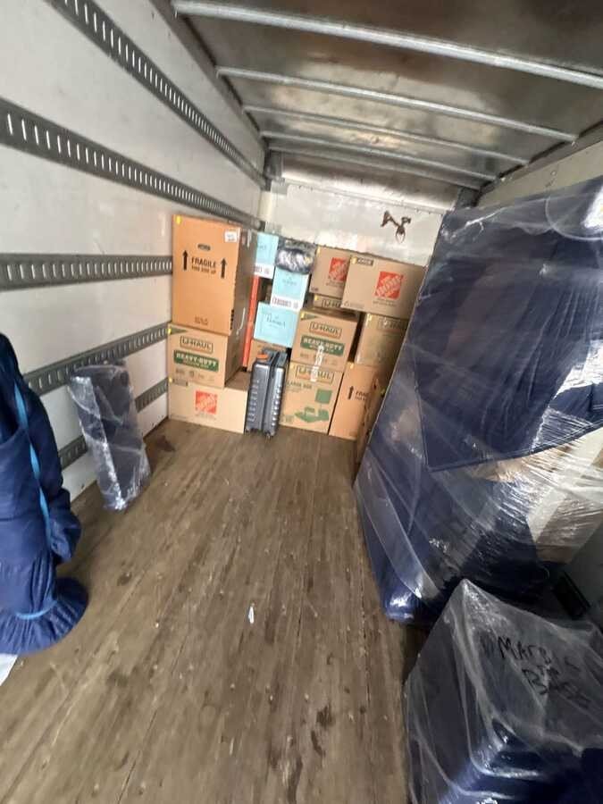 Furniture and boxes carefully arranged inside a moving truck